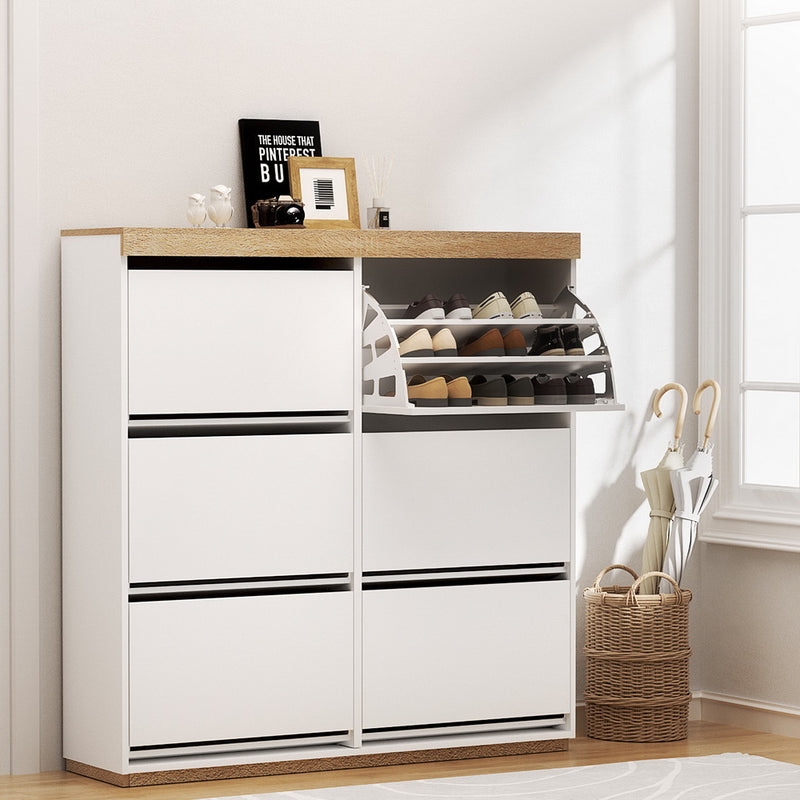 Nordwell shoe cabinet in white and pine with six flip-out drawers across three tiers and a recessed base