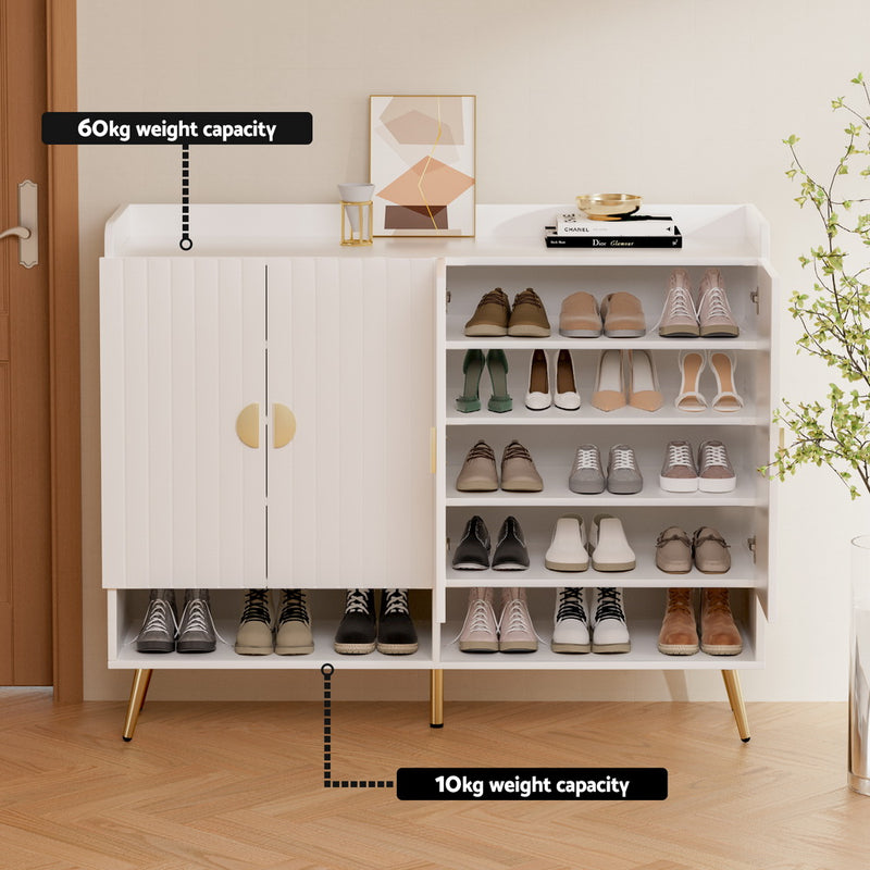 Aurelia white shoe cabinet with gold-finished metal legs, semicircular handles and adjustable shelves