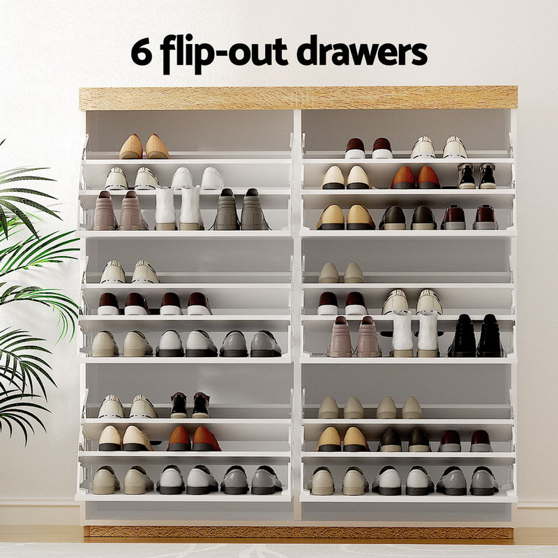 Nordwell shoe cabinet in white and pine with six flip-out drawers across three tiers and a recessed base