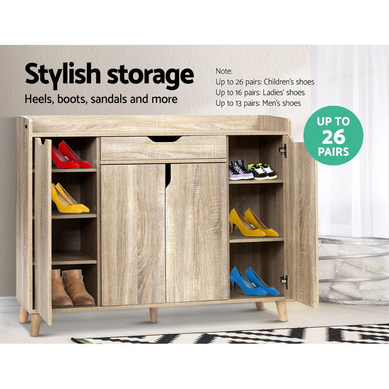 Alden 120cm shoe cabinet in pine with three enclosed storage compartments, adjustable shelves and a top drawer